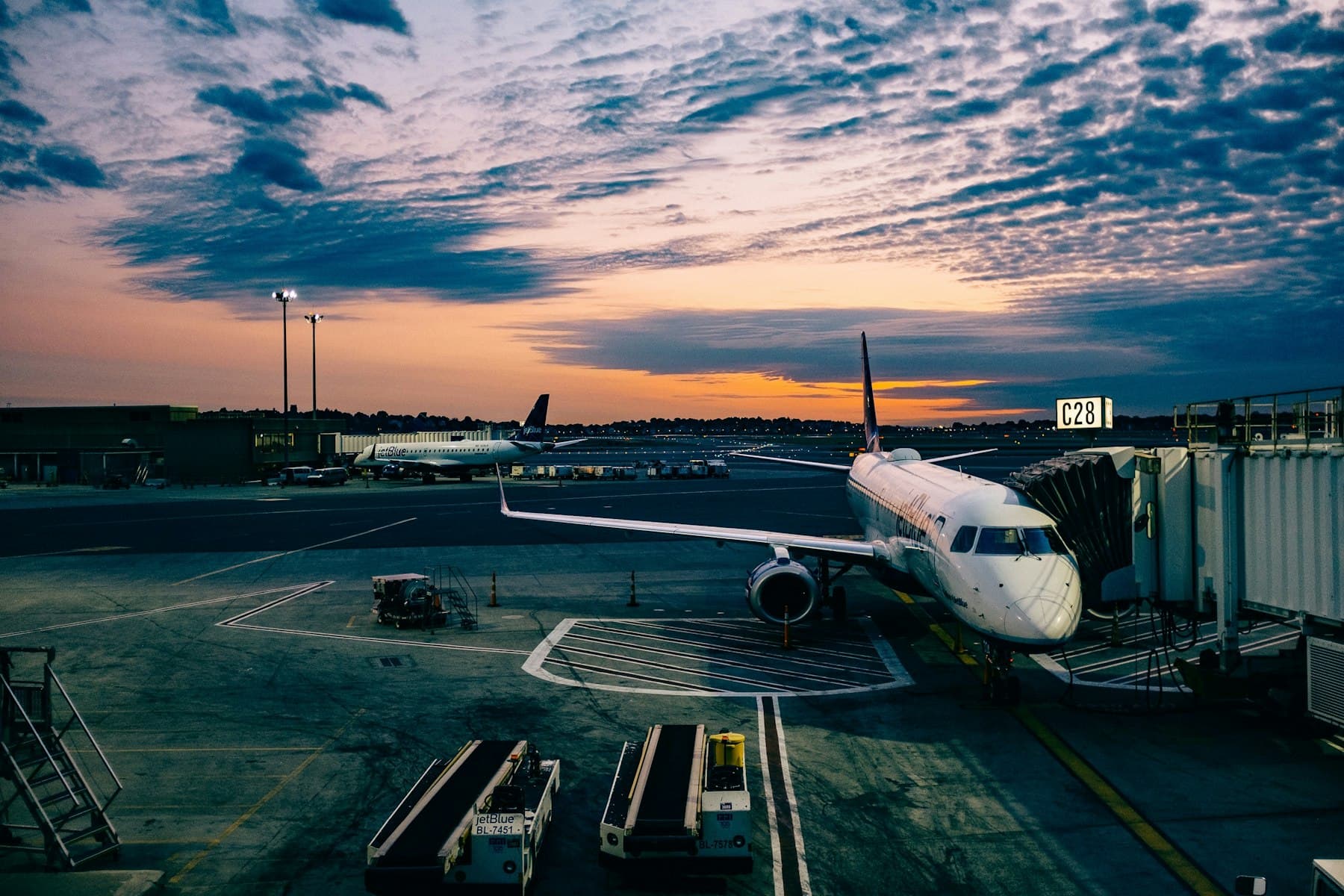 Airport hall with travellers — brand logos are not the destination.
